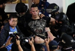 Police take hostage taker Archie Paray into custody as he speaks to media shortly after releasing all his hostages at the V-Mall in Manila, Philippines, March 2, 2020.