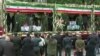 This grab taken from handout video footage released by Iran Press on May 21, 2024 shows coffins of the Iranian President and seven members of his entourage on a truck during a funerary procession in the northwestern city of Tabriz.