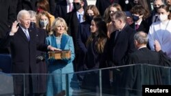 Joe Biden is sworn in as the 46th President of the United States as his spouse Jill Biden holds a bible on the West Front of the U.S. Capitol in Washington, U.S., January 20, 2021. (REUTERS/Kevin Lamarque)