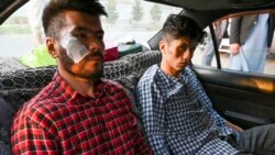 Afghan newspaper Etilaatroz journalists Neamat Naqdi (l) and Taqi Daryabi arrive at their office after being released from Taliban custody in Kabul, September 8, 2021. (Wakil Koshar/AFP)l