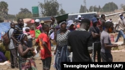 People are seen at a busy market near Harare on Nov. 15, 2021. (AP Photo/Tsvangirayi Mukwazhi)