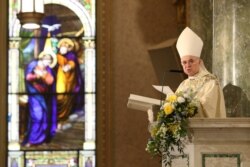 FILE - Archbishop Carlo Maria Vigano reads during the episcopal ordination of Auxiliary Bishops James Massa and Witold Mroziewski, in Brooklyn, New York, July 20, 2015.