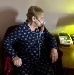 Connie Lambert resorts to oxygen from a portable tank in her bedroom when breathing becomes difficult.