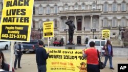 Demonstrators protest the death of Freddie Gray, who died a week after he was rushed to the hospital with spinal injuries following an encounter with several Baltimore police officers, outside Baltimore City Hall, April 20, 2015. 