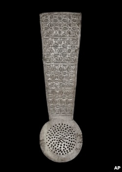 FILE - In this photo provided by the Victoria and Albert Museum, London January 25, 2024 a view of a silver spoon with repoussé and punched decoration and a broad flat handle, originating from Ghana.