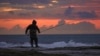 Tareq Aweid fishes at sunset near the border with Lebanon in Nahariya, Israel, Nov. 28, 2024. Aweid said he did not think the 60-day ceasefire between Hezbollah and Israel would last long. "No, no, the rockets will fall again."