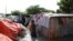 A Somali man airs his clothes dampened by floodwaters on his makeshift shelter after heavy rain in Mogadishu, Somalia, Oct. 21, 2019. 