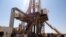 FILE - Engineers and visitors explore an exploratory well near Dharoor town, from the port of Bosasso on the Gulf of Aden in Puntland, Somalia.