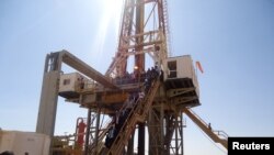 FILE - Engineers and visitors explore an exploratory well near Dharoor town, from the port of Bosasso on the Gulf of Aden in Puntland, Somalia.