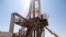FILE - Engineers and visitors explore an exploratory well near Dharoor town, from the port of Bosasso on the Gulf of Aden in Puntland, Somalia.