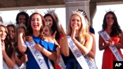 FILE - Contestants attend a welcoming ceremony for the Miss America competition in Atlantic City, N.J., Aug. 30, 2017. On May 17, 2018, the Miss America Organization announced it has installed women in the organization's three top leadership posts following an email scandal last winter involving male leaders. 