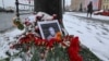 A portrait of Russian military blogger Vladlen Tatarsky, (real name Maxim Fomin), who was killed in the cafe explosion the day before, is placed among flowers near the blast site in Saint Petersburg, Russia April 3, 2023. 