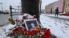 Potret blogger militer Rusia Vladlen Tatarsky, (nama asli Maxim Fomin), yang tewas dalam ledakan kafe sehari sebelumnya, ditempatkan di antara bunga dekat lokasi ledakan di Saint Petersburg, Rusia 3 April 2023. (REUTERS/Anton Vaganov)