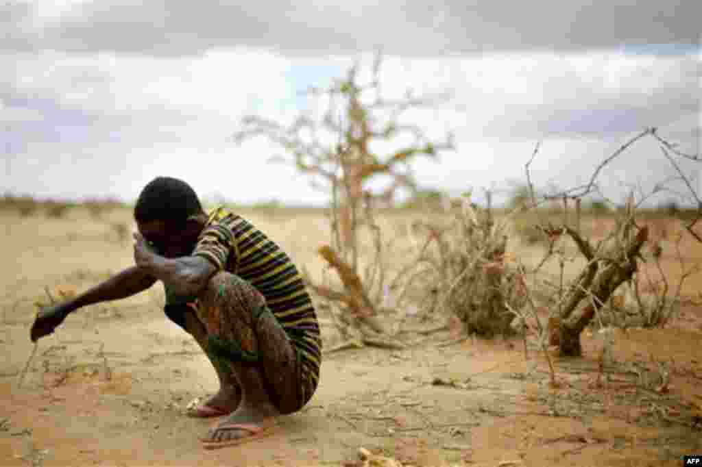 CORRECTS DATE-Muhumed Surow grieves following the burial of his 12-month-old daughter 12-month-old Liin Muhumed Surowlays at UNHCR's Ifo Extention camp outside Dadaab, Eastern Kenya, 100 kms (60 miles) from the Somali border,Saturday Aug. 6, 2011. 