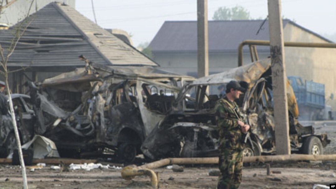 A police officer guards the site of a powerful explosion on the outskirts of Makhachkala, Dagestan, May 4, 2012. 