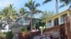 FILE - Sandbags are piled up in front of properties damaged by severe beach erosion in the Rocky Point neighborhood of Oahu's North Shore in Haleiwa, Hawaii, Dec. 31, 2013.