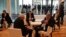 Businessmen check their phones during a break at Argentina's Business and Investment Forum in Buenos Aires, Argentina, Tuesday, Sept. 13, 2016.