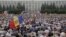 Protesters carry Moldova's national flags during an anti-government rally, organised by the civic platform "Dignity and Truth" (DA), in central Chisinau, Moldova, Sept. 6, 2015. 