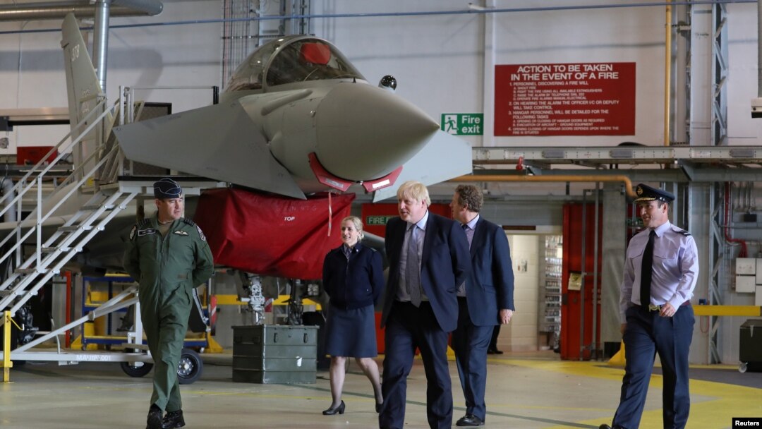 Britain's Prime Minister Boris Johnson walks next to a Typhoon fighter jet at RAF Lossiemouth, during a visit to the Highlands and Northern Isles of Scotland, in Moray, Scotland, Britain July 23, 2020. Andrew Milligan/Pool via REUTERS