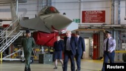 Britain's Prime Minister Boris Johnson walks next to a Typhoon fighter jet at RAF Lossiemouth, during a visit to the Highlands and Northern Isles of Scotland, in Moray, Scotland, Britain July 23, 2020. Andrew Milligan/Pool via REUTERS