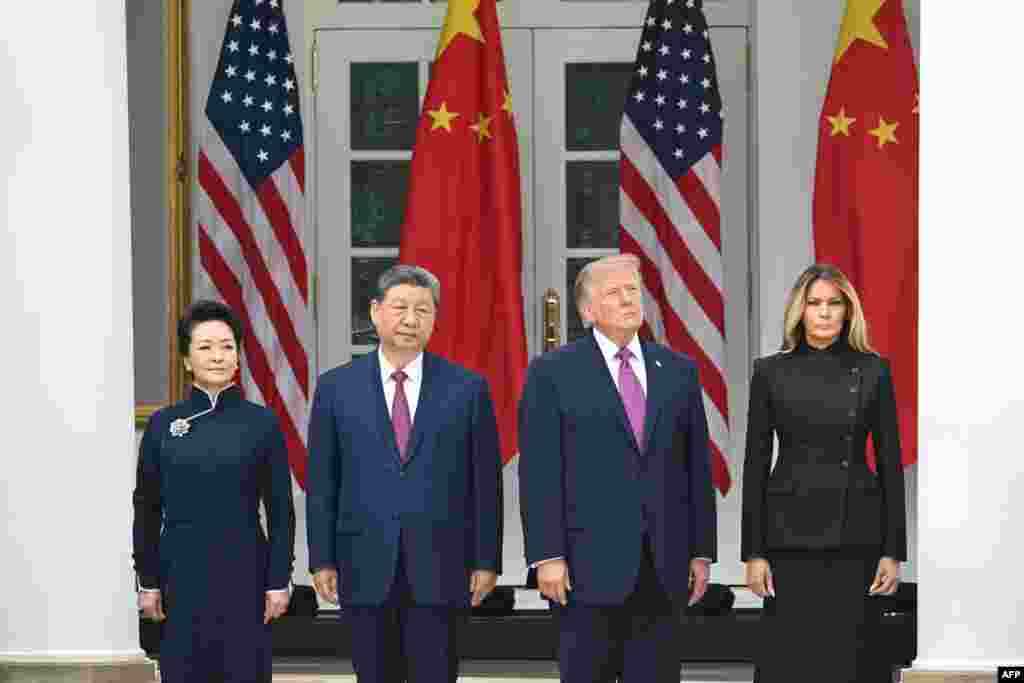 (L/R) China's First Lady Peng Liyuan, China's President Xi Jinping, US President Donald Trump and US First Lady Melania Trump look on during a military review in the Rose Garden of the White House in Washington, DC, on September 24, 2026.