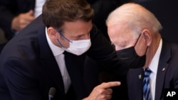 U.S. President Joe Biden, right, speaks with French President Emmanuel Macron during a plenary session during a NATO summit at NATO headquarters in Brussels, Monday, June 14, 2021. U.S. President Joe Biden is taking part in his first NATO summit,…