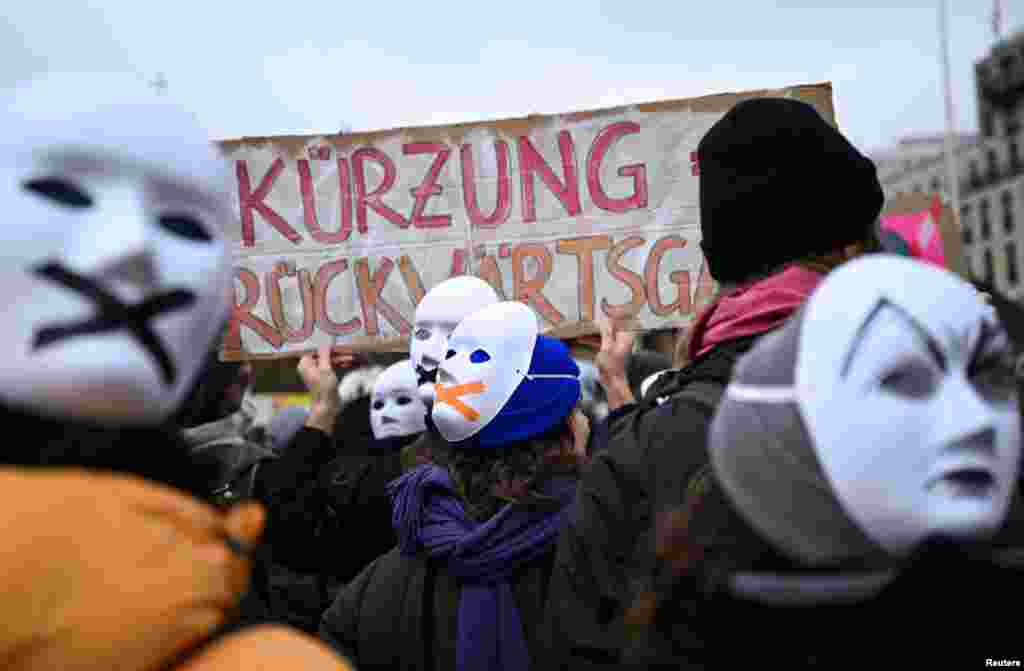 Artists and cultural workers wear masks as they attend a rally to protest under the message &quot;Save Berlin&#39;s culture&quot; against budget cuts in the culture sector, in front of the Brandenburg Gate in Berlin, Germany.