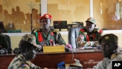FILE - Judges sit in the courtroom during a trial at a court in the capital Juba, South Sudan, May 30, 2017. The country has announced plans to create a hybrid court to deal with atrocities commited during its years of conflict. 