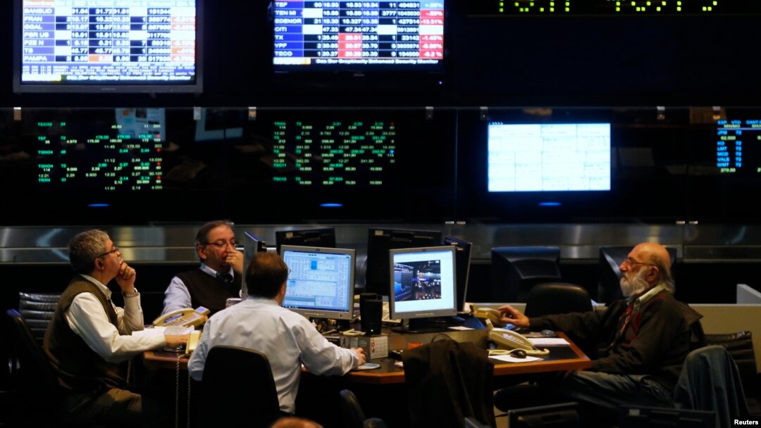 Argentine stockbrokers work on the floor of the Buenos Aires Stock Exchange Monday. The U.S. Supreme Court declined to hear Argentina's appeal over its battle with hedge funds that refused to take part in its debt restructurings, June 16, 2014. 