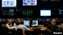 Argentine stockbrokers work on the floor of the Buenos Aires Stock Exchange Monday. The U.S. Supreme Court declined to hear Argentina's appeal over its battle with hedge funds that refused to take part in its debt restructurings, June 16, 2014. 