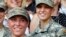 U.S. Army 1st Lt. Shaye Haver, left, and Capt. Kristen Griest pose for photos with other female West Point alumni after Ranger school graduation at Fort Benning, Ga., Aug. 21, 2015. 