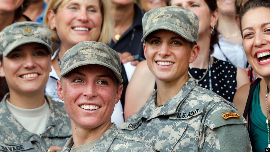 FILE - U.S. Army 1st Lt. Shaye Haver, center, and Capt. Kristen Griest, right, pose for photos with other female West Point alumni after an Army Ranger school graduation ceremony at Fort Benning, Ga., Aug. 21, 2015. 