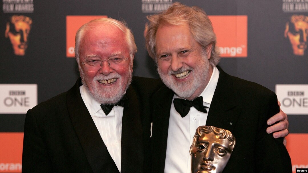 Director David Putnam (R) is embraced by fellow British Director Richard Attenborough (L) after winning the Fellowship Award at the British Academy of Film and Television Arts awards in central London in this February 19, 2006 file photo.