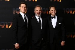 FILE - Actor George MacKay, from left, director Sam Mendes and actor Dean-Charles Chapman pose for photographers upon arrival at the World premiere of the film '1917,' in central London, Dec. 4, 2019.