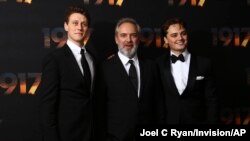 Actor George MacKay, from left, director Sam Mendes and actor Dean-Charles Chapman pose for photographers upon arrival at the World premiere of the film '1917', in central London, Dec. 4, 2019.