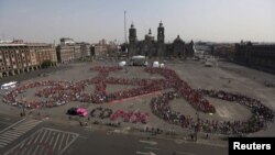 FILE - Cyclists gather to form a shape of a bicycle with the aim of promoting cycling as a mode of transport and to commemorate Bicycle Day, which is celebrated April 19 annually, at Zocalo square in Mexico City, Mexico, April 10, 2016. 