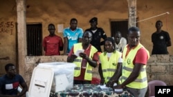 FILE - Election officials start counting votes at a polling station in the Bairro Militar area of the capital Bissau, in Guinea-Bissau, Nov. 24, 2019.