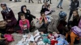 Five Syrian babies, three of them triplets (L - C), lie in blankets among their relatives as they arrive with other refugees and migrants aboard the passenger ferries Blue Star Patmos and Eleftherios Venizelos from the islands of Lesbos and Chios at the port of Piraeus, near Athens, Greece.