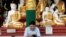 FILE - A man wears a face mask as he uses his phone at Shwedagon Pagoda in Yangon, Myanmar, Jan. 31, 2020.