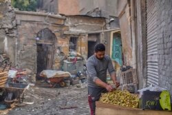 Ghareb, 34, escaped dire poverty in the countryside to sell fruit in Cairo from an abandoned bakery with six cousins. He says, "I don't care if Sissi stays or goes. I just want stability and to run my business." Sept. 21, 2019. (H. Elrasam/VOA)