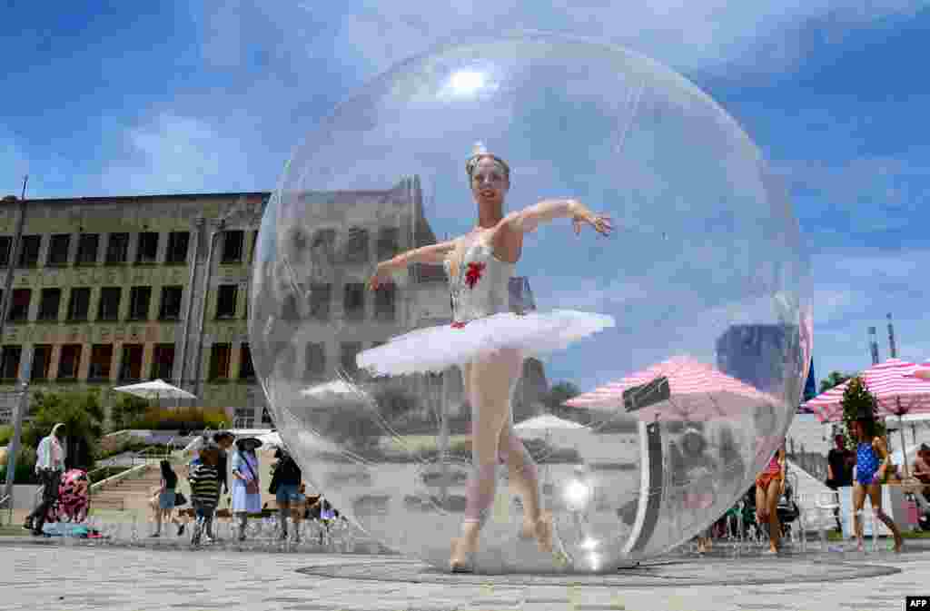 A ballet dancer poses in a giant plastic bubble as she entertains Christmas shoppers in Melbourne, Australia.