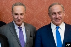 FILE— Israeli Prime Minister Benjamin Netanyahu, right, poses for a picture with Senate Minority Leader Chuck Schumer of New York, on Capitol Hill in Washington, February 15, 201