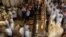 Members of the Catholic clergy hold candles as they take part in a procession at the end of Easter Mass in the Church of the Holy Sepulchre in Jerusalem's Old City April 8, 2012.