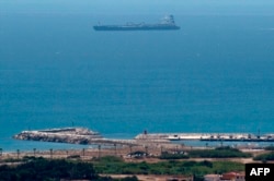 FILE - A picture taken from La Linea de la Concepcion in southern Spain shows supertanker Grace 1 suspected of carrying crude oil to Syria in violation of EU sanctions after it was detained in Gibraltar on July 4, 2019.