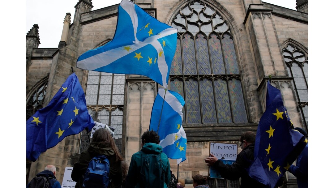 Protesters holding Scottish and European flags gather in front of St. Gilles Cathedral facing the Scottish Court of Session in Edinburgh, Scotland, Sept 4, 2019.