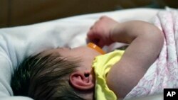 A week old baby lies in one of the ICU bays at one of the Norton Children's Hospital neonatal intensive care units, Feb. 13, 2018, in Louisville, Kentucky. This NICU is dedicated to newborns of opioid addicted mothers, that are suffering with newborn abst