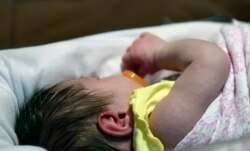 FILE - A week-old baby lies in Norton Children's Hospital neonatal intensive care unit, Feb. 13, 2018, in Louisville, Ky. This NICU is dedicated to newborns of opioid addicted mothers that are suffering with newborn withdrawal.
