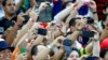 Spectators record the ongoing match between Japan and Ivory Coast with their smartphones during their 2014 World Cup Group C soccer match in Recife, Brazil, June 14, 2014.