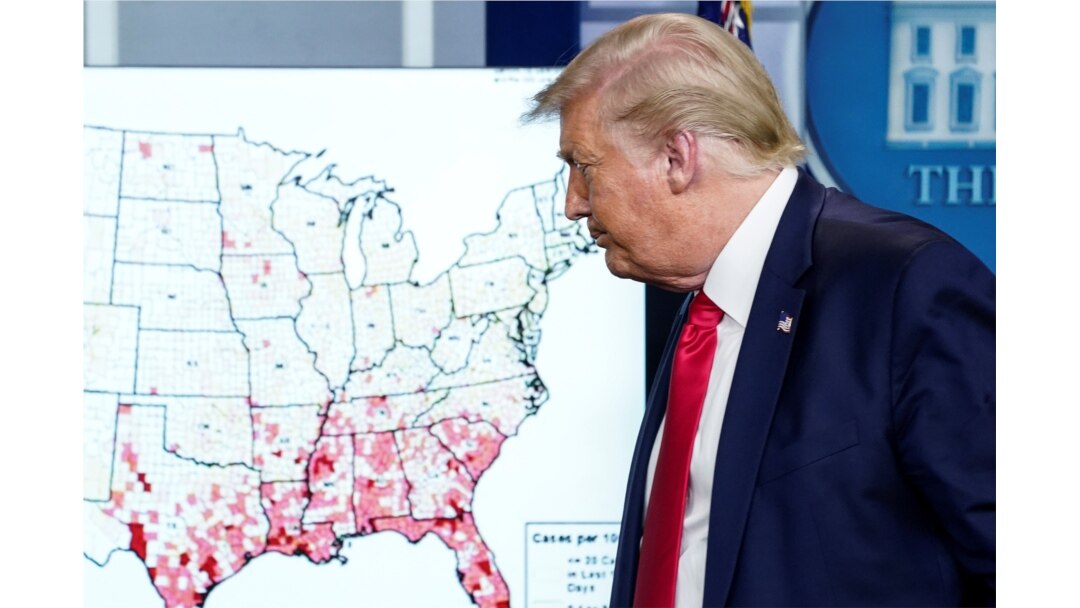 President Donald Trump walks past a U.S. map of reported coronavirus cases as he departs following a coronavirus disease (COVID-19) news briefing at the White House in Washington, July 23, 2020.