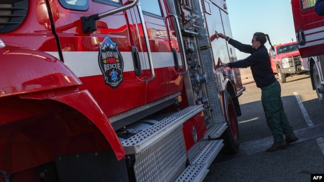 Firefighters get ready to head back to the fire line at the first responders base camp set up at Zuma Beach, on Jan. 13, 2025, in Malibu, California.